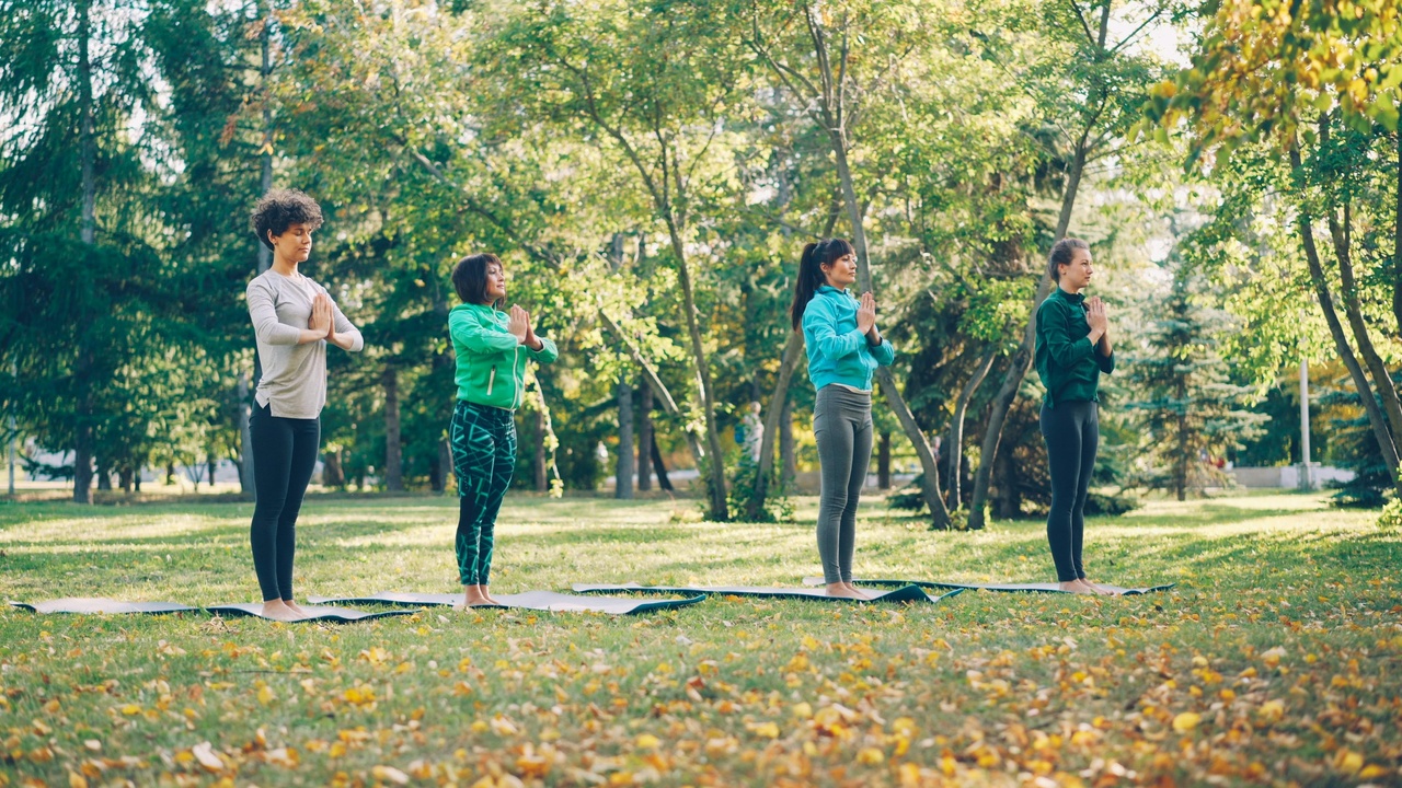 Community yoga class with diverse participants, indicating broad access and programs for veterans and prisons