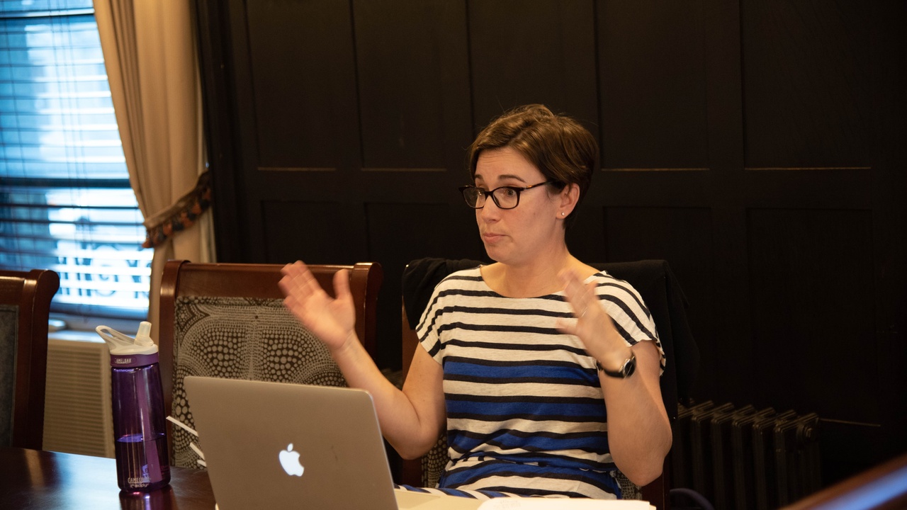 People debating bioethics with DNA imagery in the background