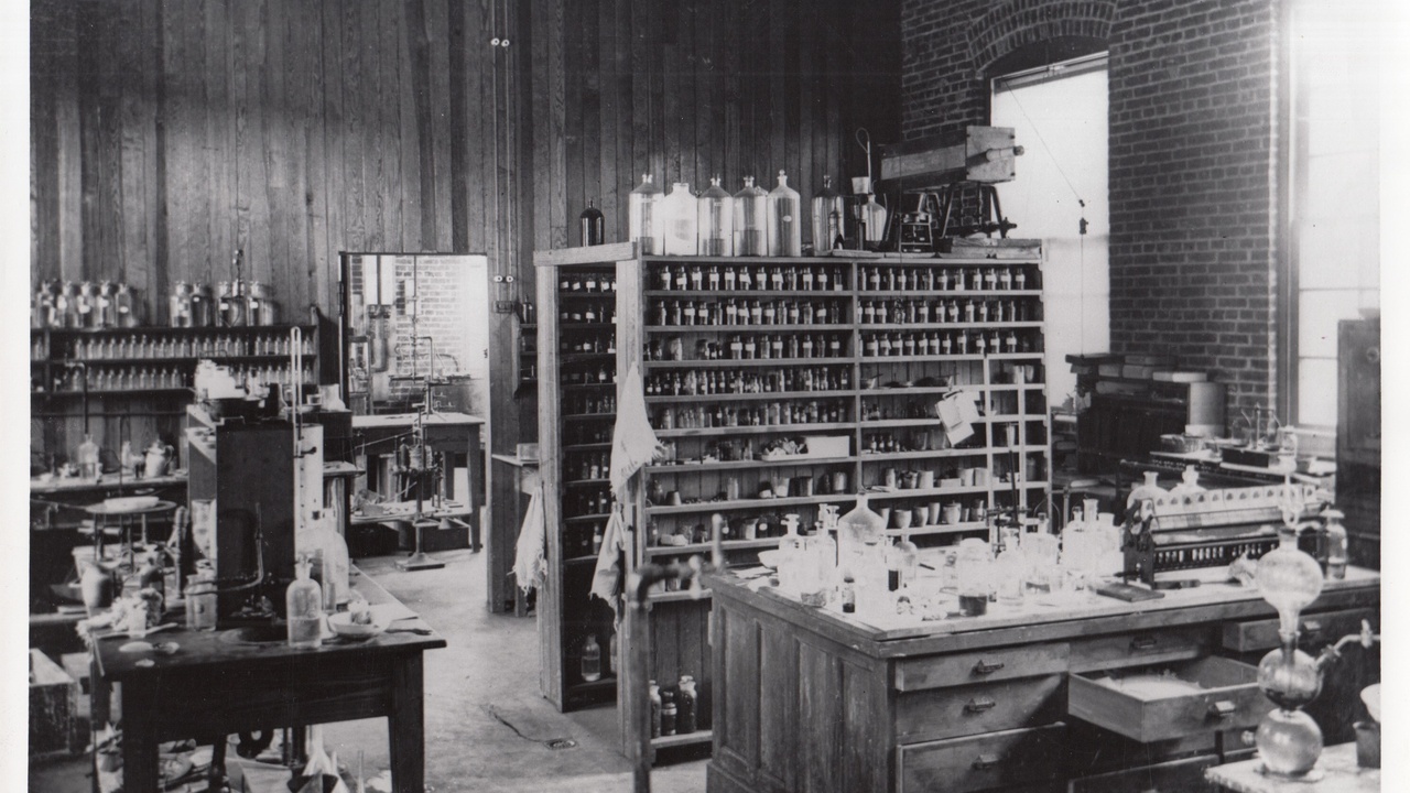 Archival portrait of Dmitri Mendeleev with a printed periodic table