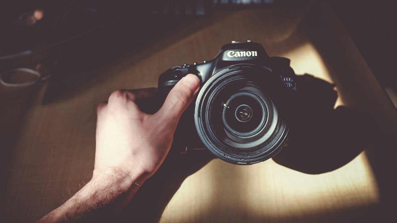 Photographer editing images on a laptop, demonstrating post-processing