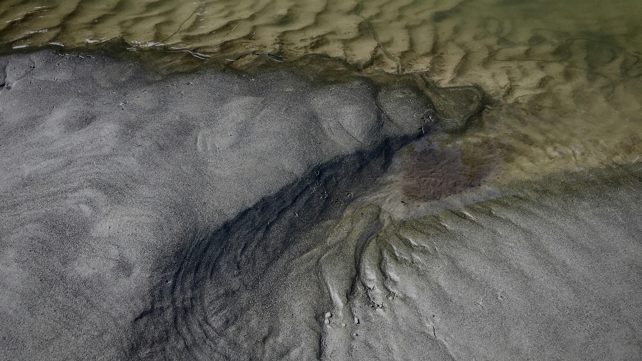 Schematic of magma solidifying into igneous rock and sediments layering in a basin