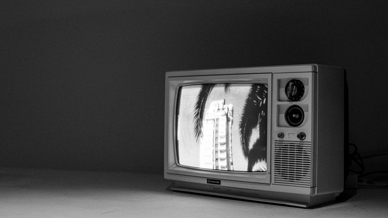 Family watching TV in living room with soft lighting