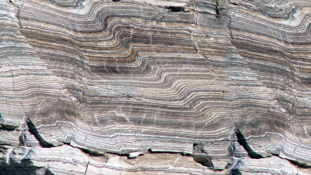 Close-up of crystalline igneous texture and layered sedimentary bedding with cross-beds