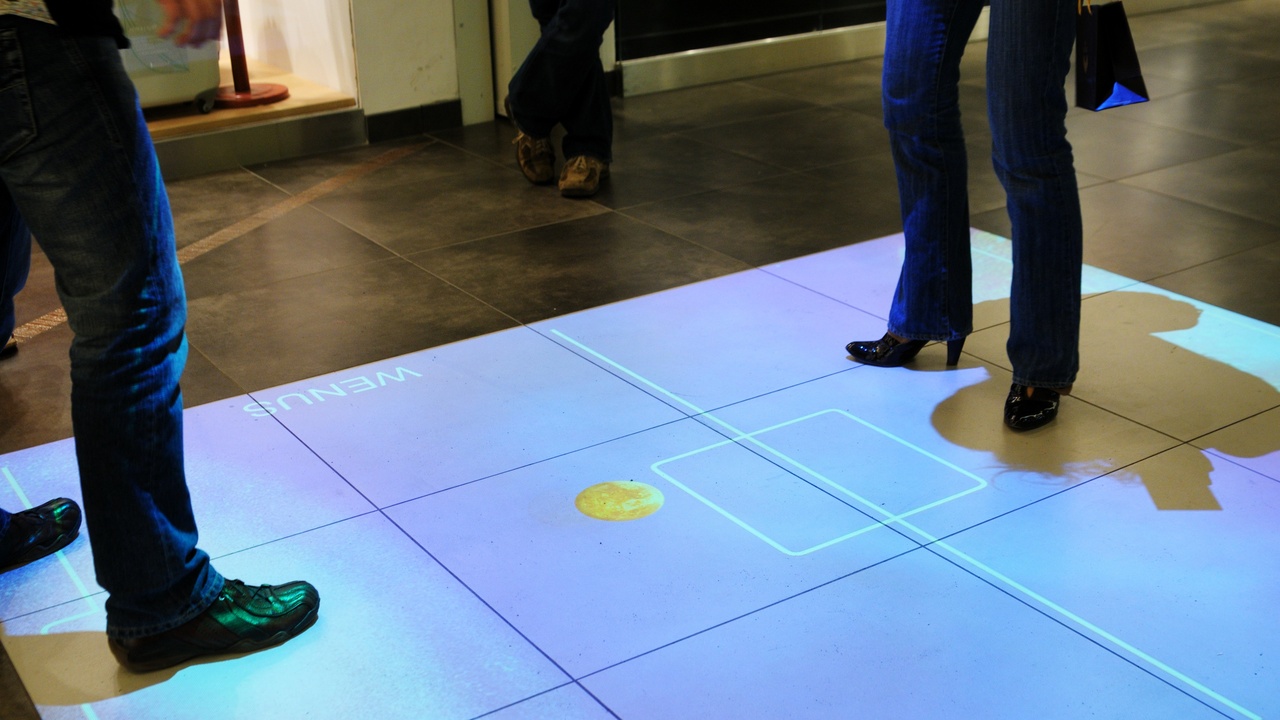 Person using a smartphone AR app to preview furniture in their living room