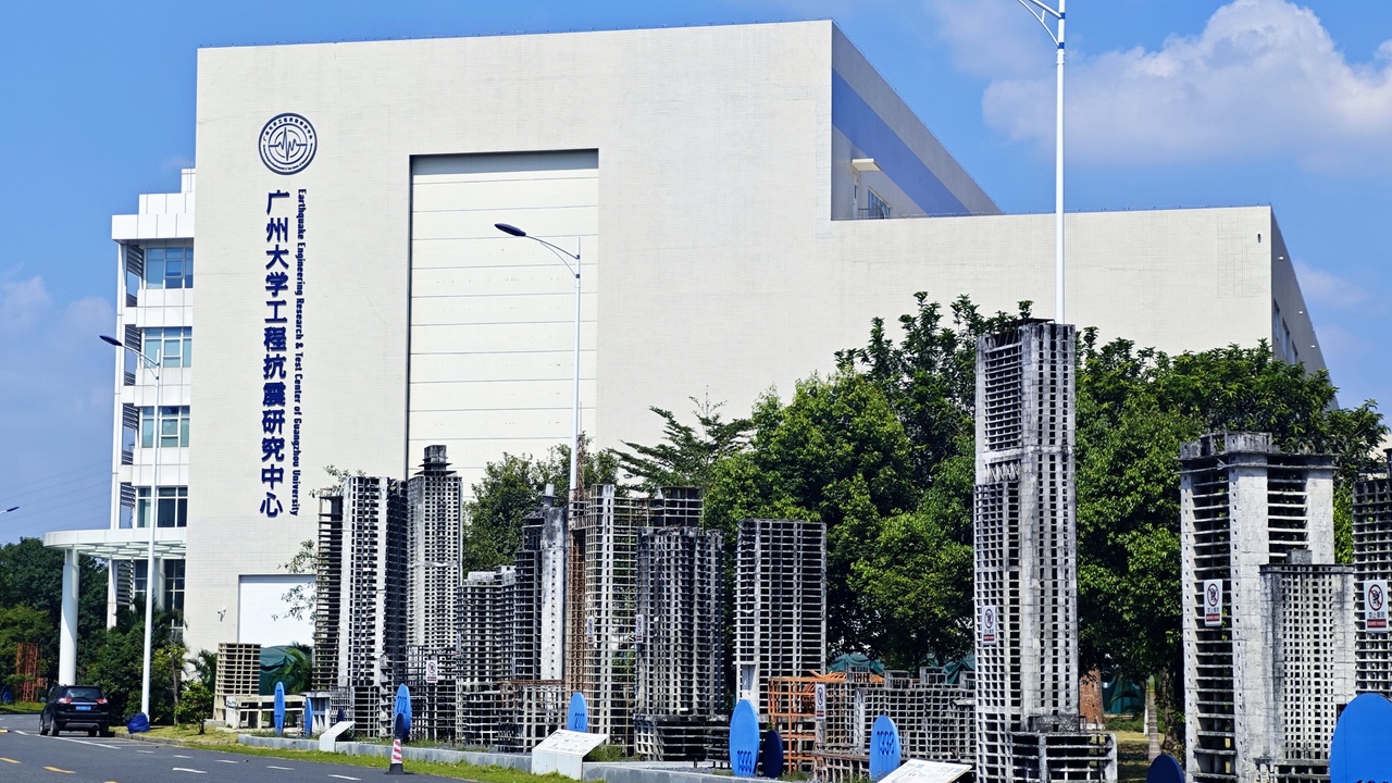 Base-isolated building and engineers retrofitting a structure