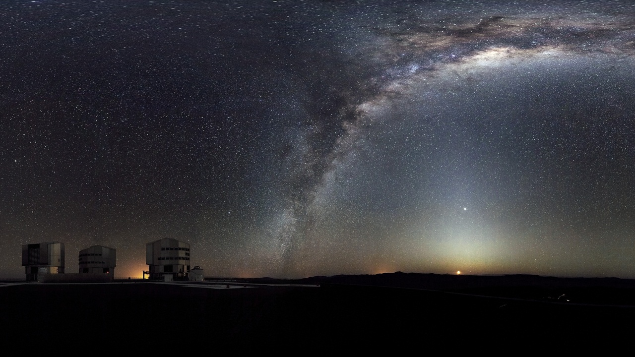 Astronomers using telescopes and analyzing astronomical data under a night sky
