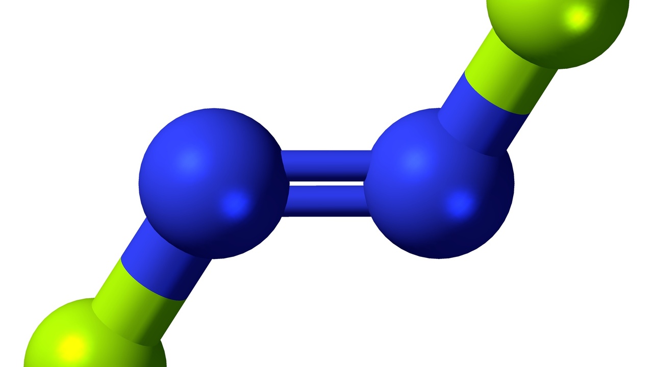 Industrial ammonia plant and molecular models illustrating nitrogen chemistry
