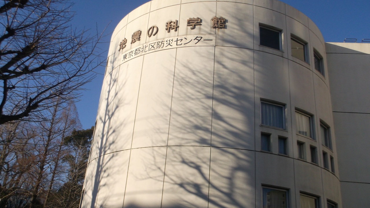 Seismology lab instruments and a colored fault map showing seismic activity