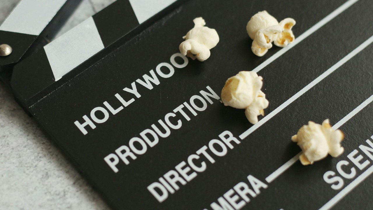 Film production meeting and a movie marketing billboard representing film production and movie marketing