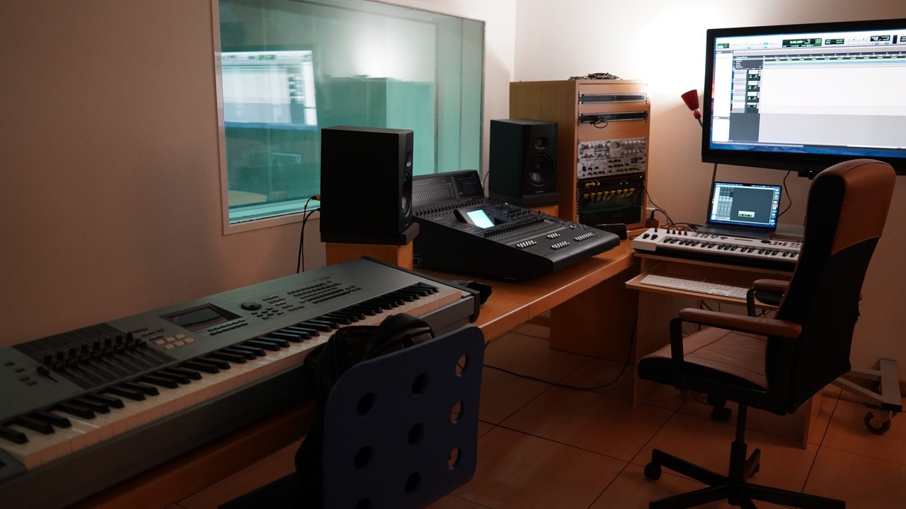 Modern music producer at a mixing desk representing production and technology in pop