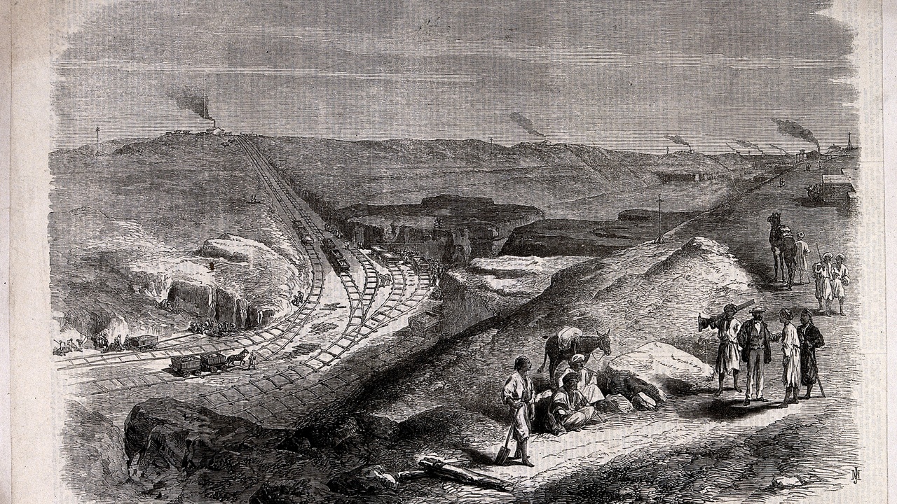 BIM model on a laptop with a drone flying over a construction site for mapping