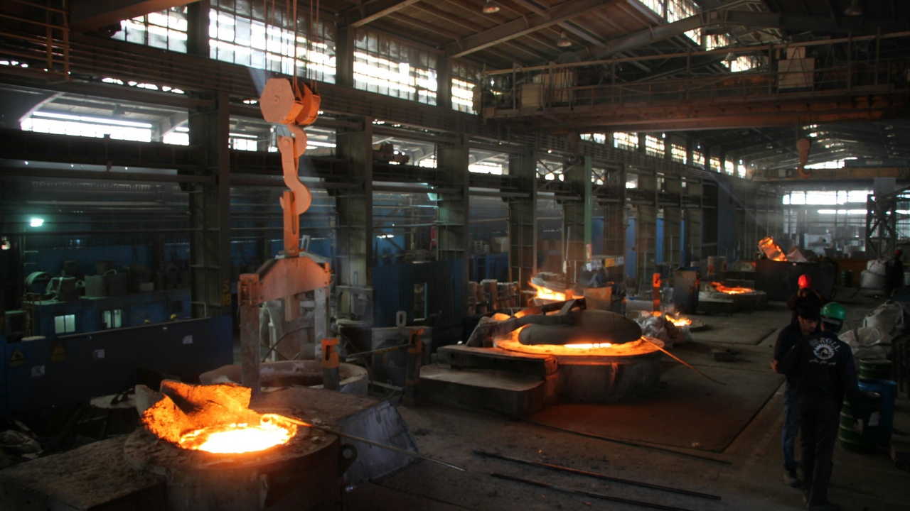 Workers at a ferrochrome plant and recycled stainless steel coils.