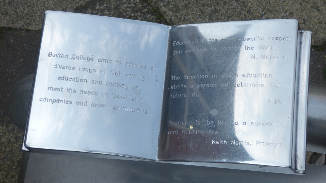 Close-up of stainless steel surface and chrome-plated automotive trim.