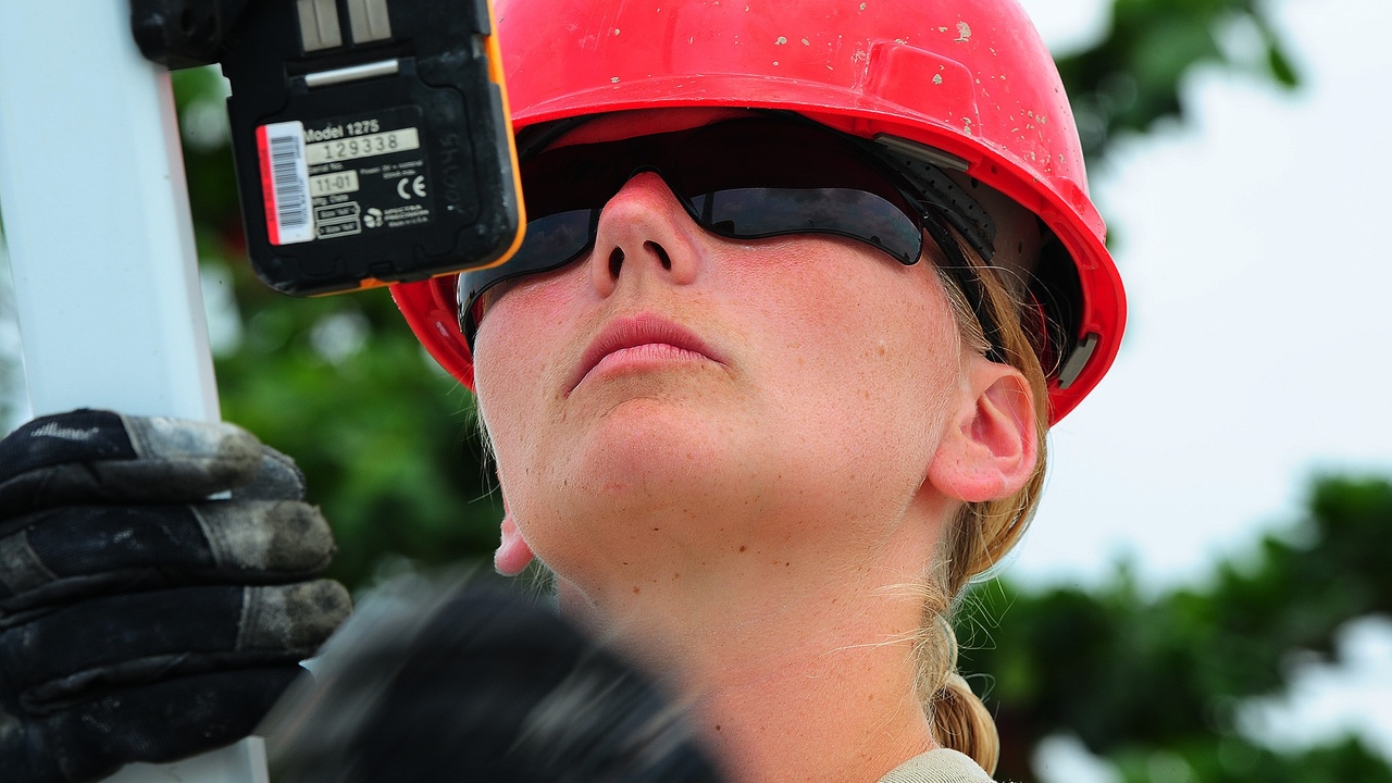 Laser level on a tripod at a construction site showing grade work