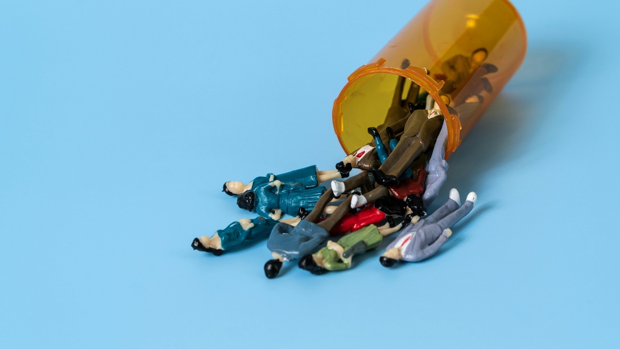 Prescription bottle and pills with a checklist for proper antibiotic use.