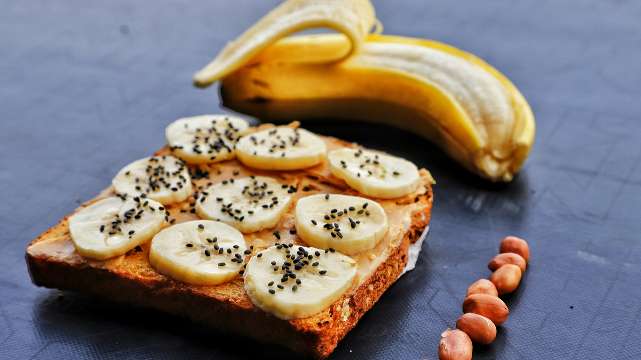 Assortment of high-potassium foods like bananas, potatoes, beans, and leafy greens