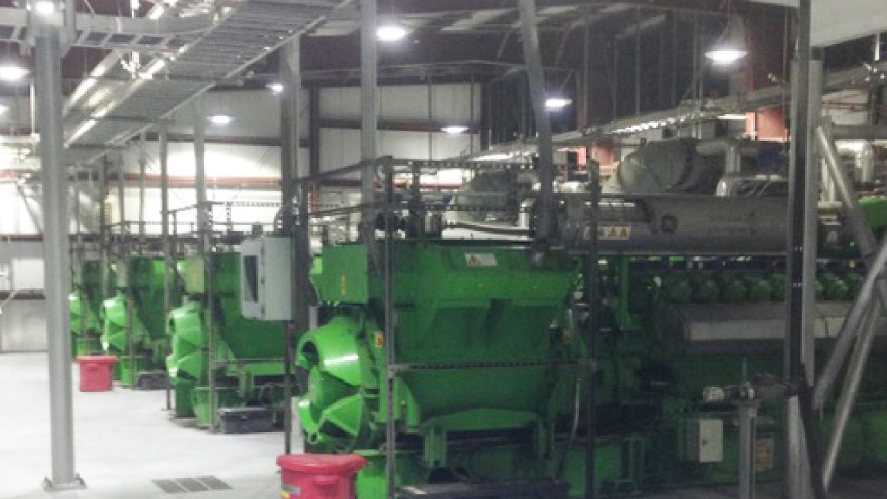 Landfill gas-to-energy facility with turbines next to a waste cell