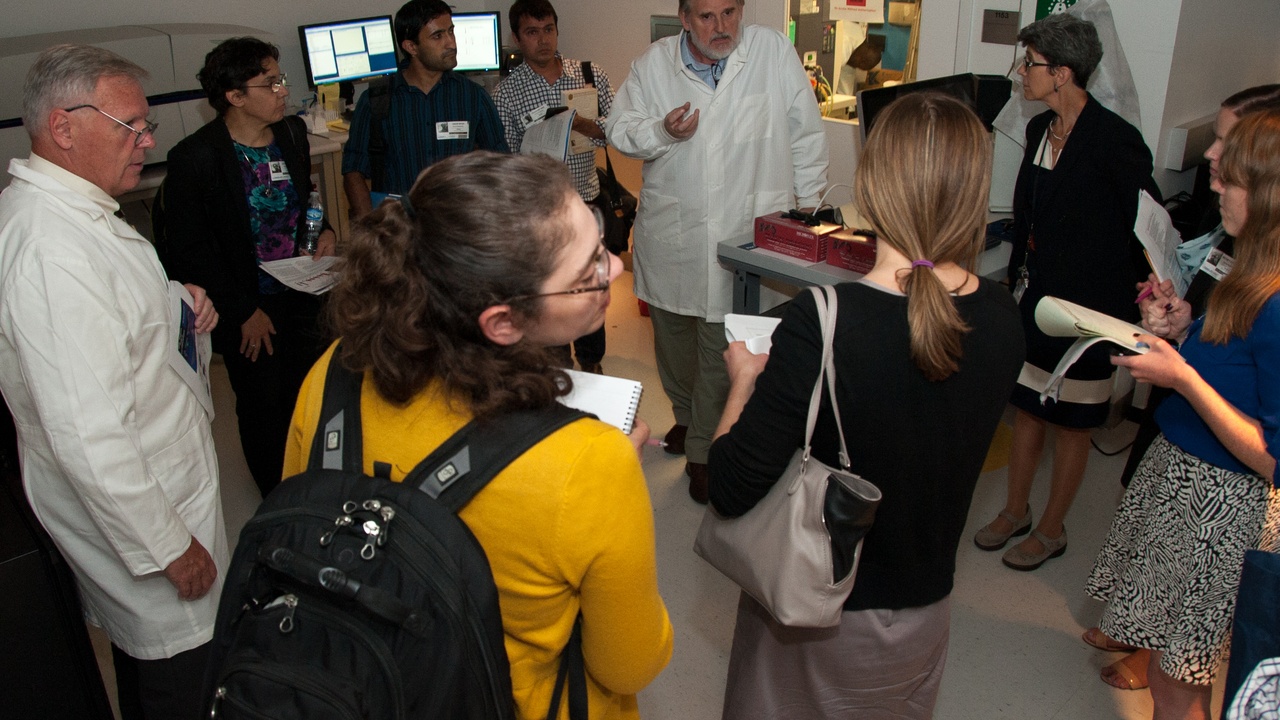 Scientist in laboratory preparing vaccine samples; clinical trials and safety monitoring imagery.