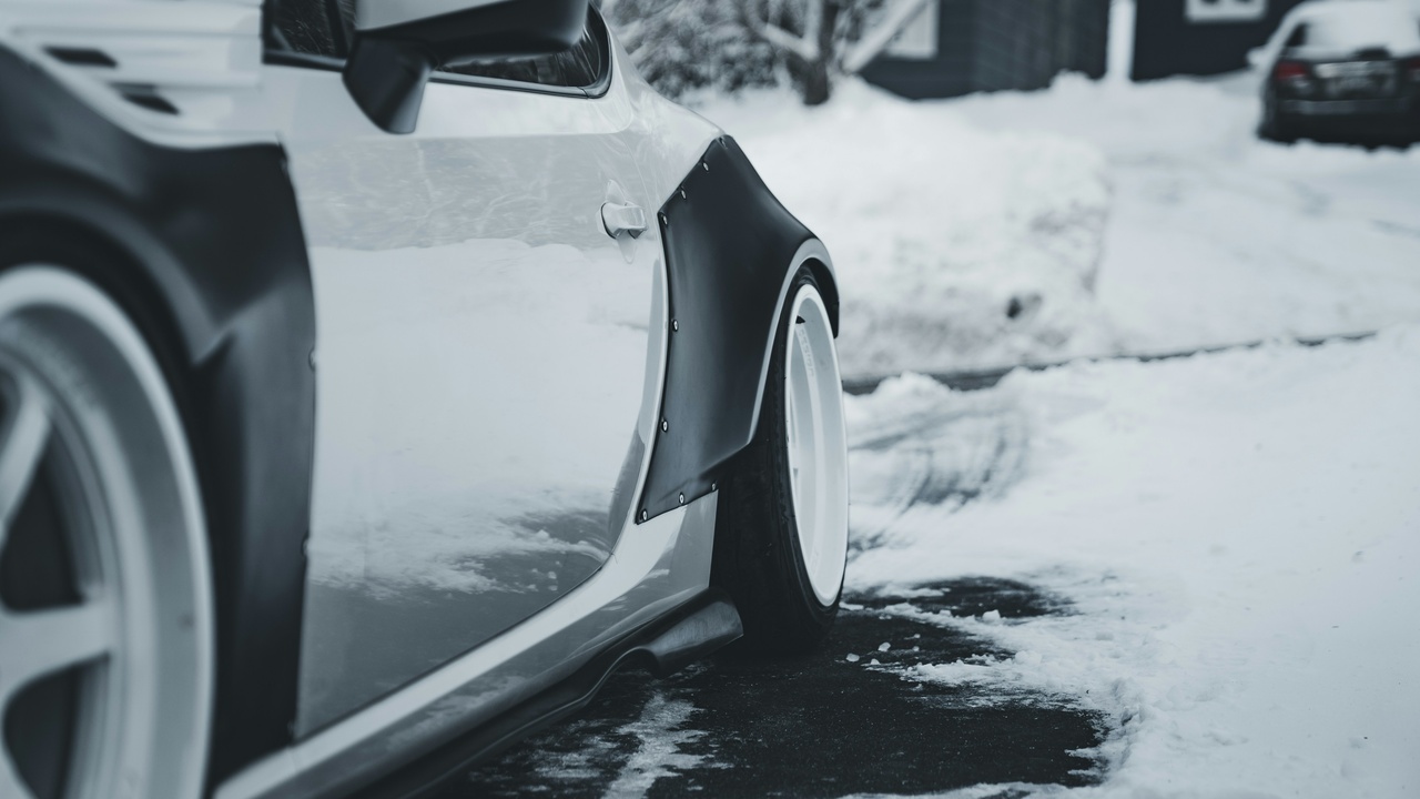 Car driving on icy road with winter tires showing stopping distance