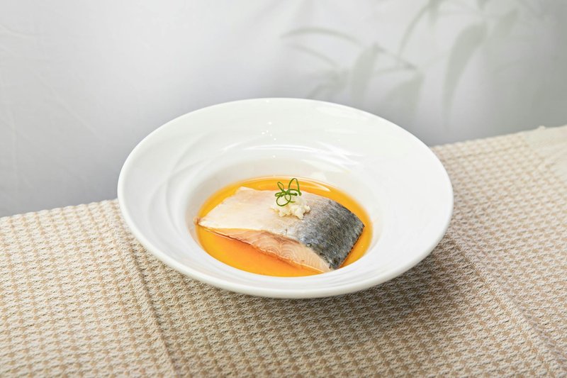 Delicious salmon fillet served in citrus sauce, elegantly plated for a gourmet dining experience.