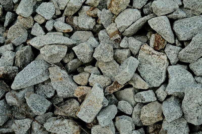 A detailed view of rough granite stones, showcasing their texture and natural color.