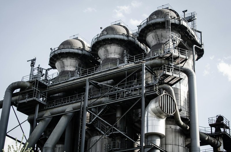 A powerful industrial structure with pipes and machinery in Duisburg, Germany.