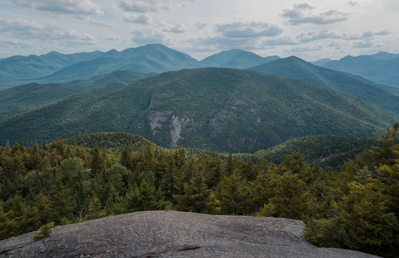 Breathtaking view of the Adirondack Mountains from Keene Valley, showcasing lush forests and mountain peaks.