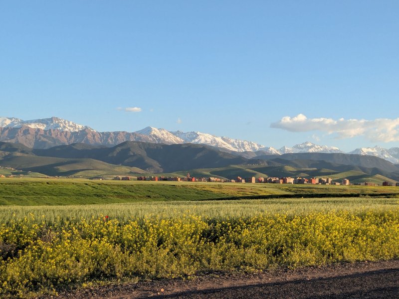 Beautiful view of the Atlas Mountains and fields in Marrakesh, Morocco during the day.