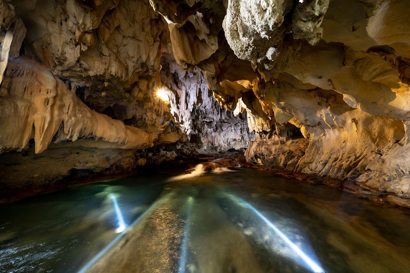 Explore a magnificent cave featuring unique rock formations and a serene underground river.