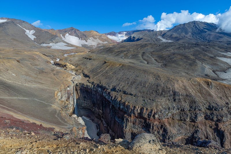 Stunning mountain landscape with valleys, rugged terrain, and clear blue skies.