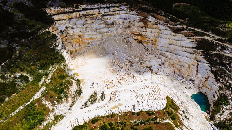 A breathtaking aerial view of a marble quarry surrounded by lush greenery in Thessaloniki, Greece.
