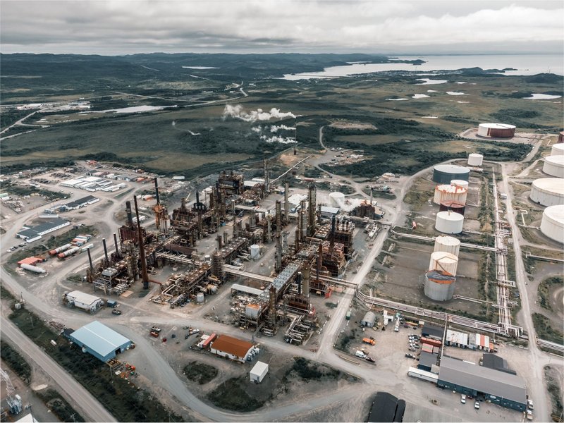 Aerial view of a large industrial complex with various structures and storage tanks.