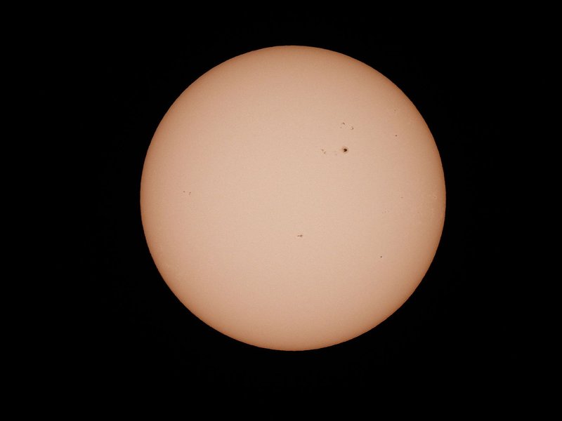 Detailed photograph of the Sun showcasing sunspots against a black backdrop.