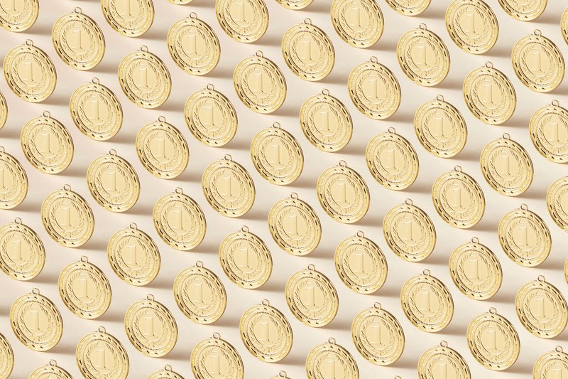 Seamless pattern featuring gold medals on a flat background, ideal for sports themes.