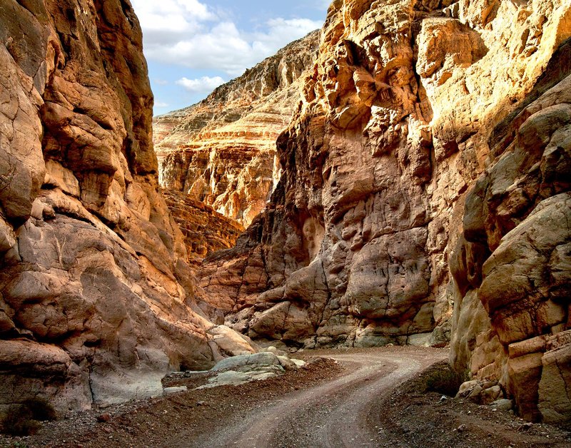 Explore a stunning sandstone canyon with a winding path perfect for travel and adventure.