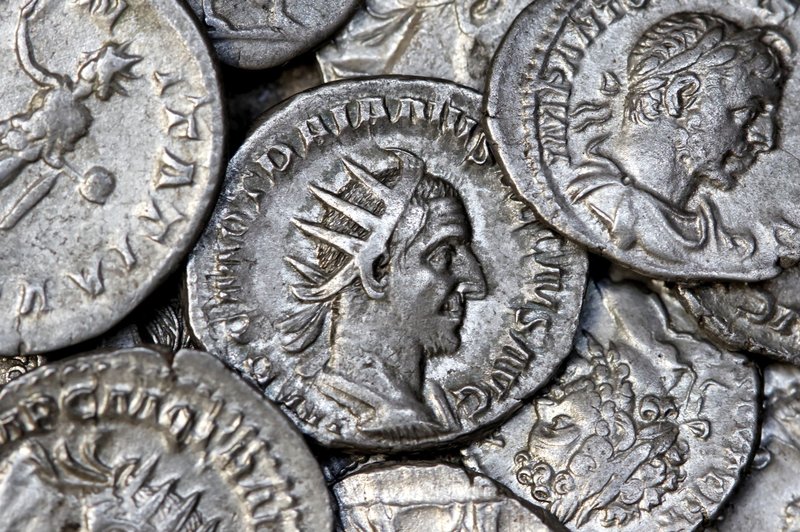 Close-up view of ancient Roman silver coins showcasing detailed engravings and historical significance.