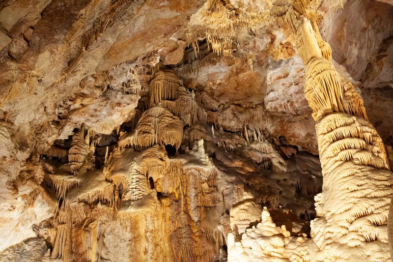 Explore the stunning stalactites and rock formations in a cave near Meyrueis, France.