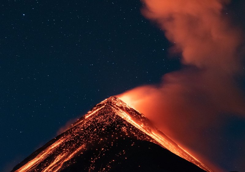 Stunning volcanic eruption in Guatemala captured at night with glowing lava and smoke.
