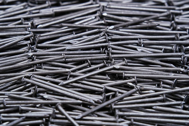 High-resolution image of numerous metal nails arranged closely together.