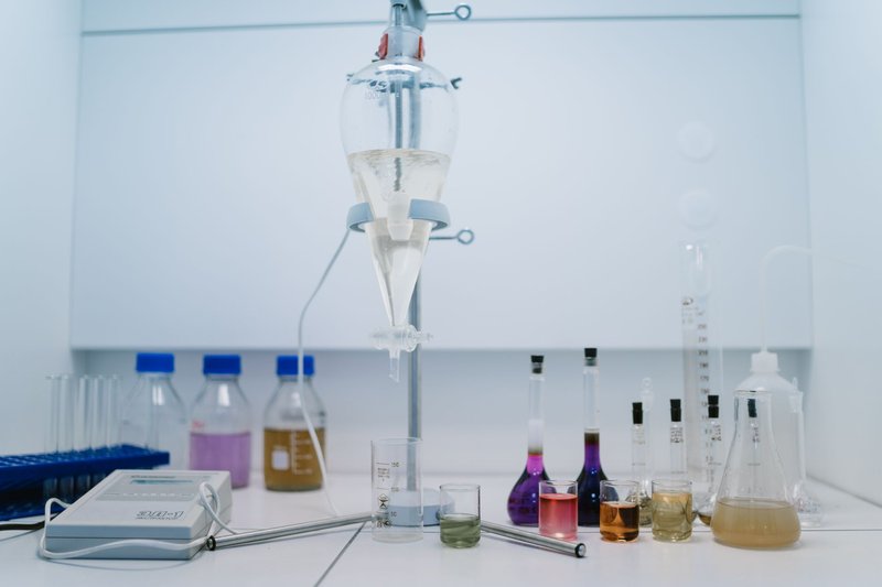 A detailed view of laboratory glassware with colorful chemicals, ideal for scientific research and experiments.