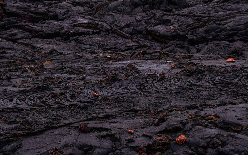 Close-up view of intricate textures on a cooled lava surface, showcasing geological formations.