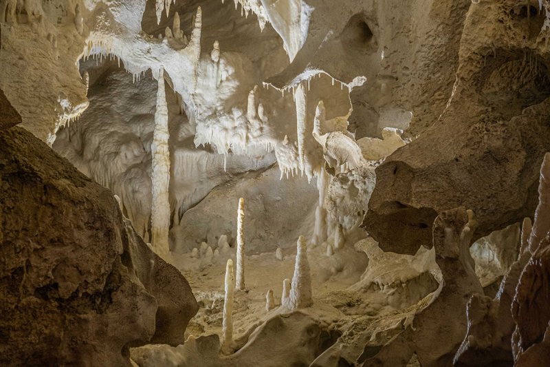 Stunning limestone cave interior showcasing stalactites and stalagmites in a natural wonder.