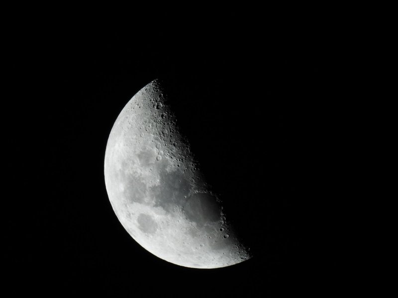 Close-up of the moon in black and white, showcasing its craters and texture.