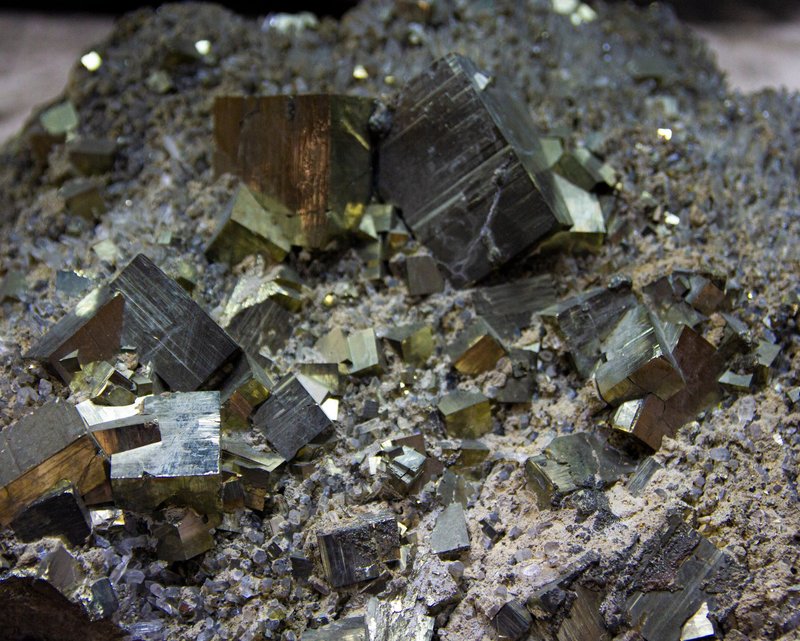 Detailed close-up of pyrite crystal formations showcasing geometric gold and silver tones.
