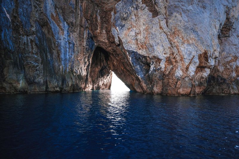 Breathtaking view of rough stone formation in tranquil turquoise ocean water at daylight