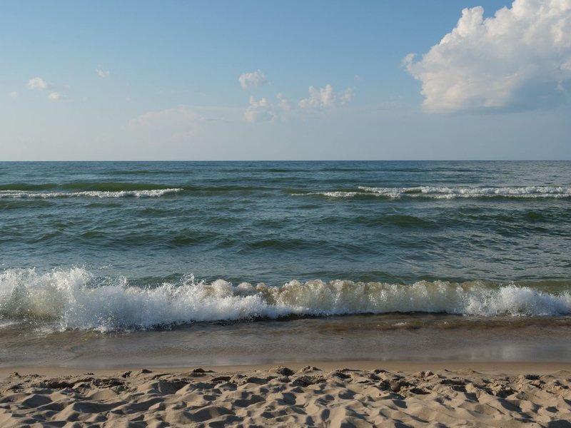 Peaceful view of Lake Michigan waves hitting the sandy shores at Portage, Indiana.