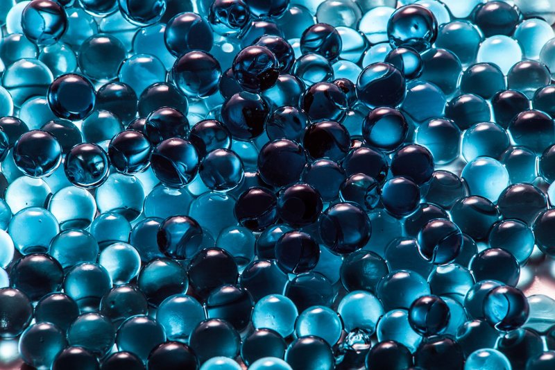 A collection of vibrant blue translucent spheres creating a modern abstract pattern.