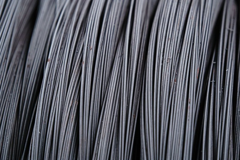 Detailed macro shot of intertwined metal wires, showcasing industrial texture.