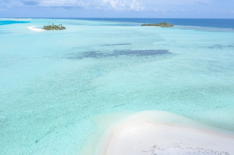 Stunning aerial shot of Guraidhoo's turquoise waters and sandy shores in Maldives.