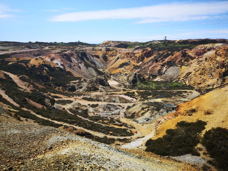 Vibrant aerial view of Parys Mountain's historic copper mine in Wales showcasing rugged geological formations.